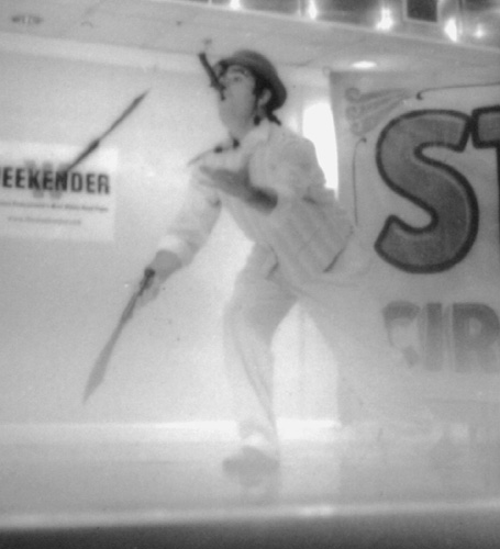 Mr. Pennygaff simultaneously swallows a sword and juggles machetes
 [This photograph is copyright � 2006 James G. Mundie. All rights reserved.]